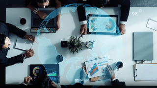 corporate executives at a private investment firm reviewing data