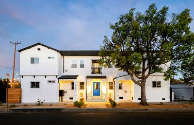 Beautiful white house with black roof and blue door at 3400 Somerset in Los Angeles, California